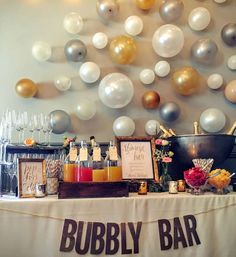 feather boa backdrop and banner - with a champagne / mimosa bar